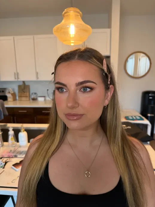 A makeup client’s selfie showing her finished look